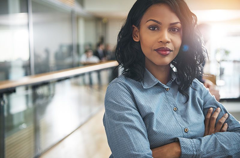 Beautiful black businesswoman with arms crossed in office Strong Business Woman